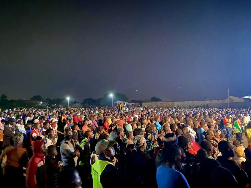 A crusade crowd worshipping at night